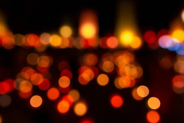 Christmas and Happy new year on blurred bokeh lights on black background.