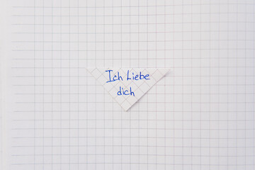  I love you written in german on a notebook paper.