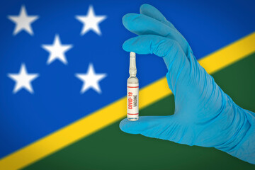 New coronavirus vaccine with the flag of Solomon Islands in the background. Solomon Islands medical...