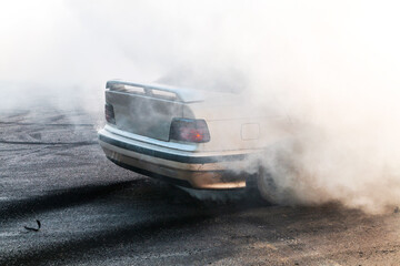 Drift car wheel drifting on the track with smoking tires. scraping the asphalt while racing