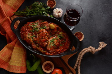 Chicken cacciatore with bell peppers, tomatoes, black olives. Italian food