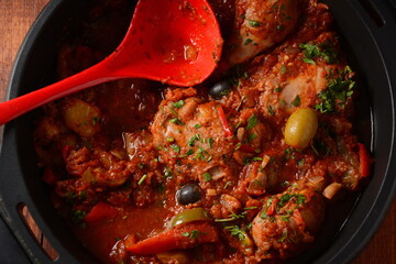Chicken cacciatore with bell peppers, tomatoes, black olives. Italian food