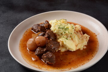 Greek beef stifado. Stew with beef, onion bulbs, cinnamon and spices 