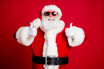 Portrait of his he nice handsome content glad cheerful cheery bearded Santa showing two double...