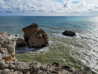 Huge rock formations on the shore of Mediterranean Sea, Cyprus. Petra tou Roumiou Beach.