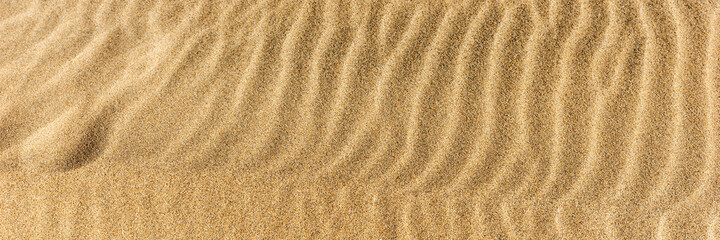 Fototapeta na wymiar Closeup sand on the beach formed by wind. Panoramic image