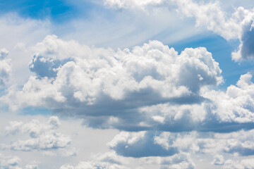 Cumulus of irregular clouds making their way after a storm with the blue sky in the background
