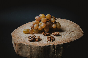 Table white grapes and wanlnuts on wooden table. High quality photo