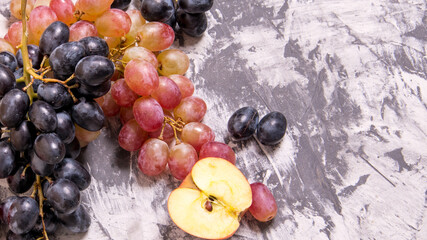 Red and green apples with a bunch of grapes on a black and white background,close-up,background,Wallpaper,postcard,advertising