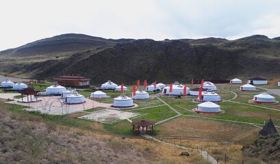 View of a nomadic camp Aldyn-Bulak and white yurts. Indigenous life and home, Indigenous cultural...