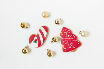 new year and christmas gingerbread cookies and christmas toys. tree shaped. top view. white background. minimalist style.