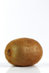 Whole kiwi fruit isolated on white background closeup. Kiwifruit flatlay. Flat lay, top view.