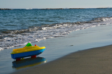 Toy Boat Parked on a Sandy Mediterranean Beach