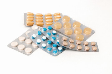 close up different pills in blisters on white table. prophylaxis against flu