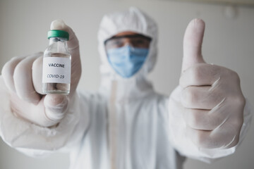 Fototapeta premium Okey sign with the hand of the doctor who found the covid 19 virus vaccine.