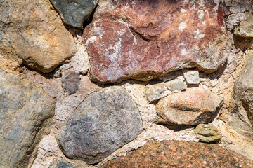 Stone wall. Uneven, old, rough, irregular granite wall. Natural textured background
