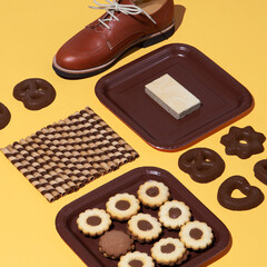 Stylish chocolate isomertric composition. Cookies and vintage retro shoes. Fashion funny sweet christmas holiday. Winter time concept art.