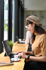 Portrait of female office worker working with laptop in meeting room.