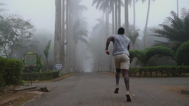 man running into the mysterious jungle