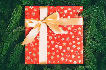 Top view of holiday gift box and fir tree branches with empty space for your design. New year ornament concept