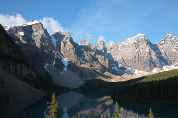 Fototapeta premium View of The Moraine Lake with snow covered mountain peaks during summer in Banff National Park, Canadian Rockies, Alberta, Canada.