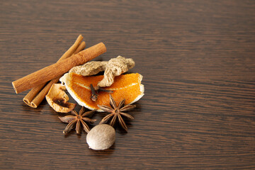 spices for mulled wine on dark wood background