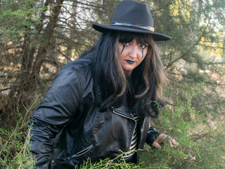 Woman posing in disguise for Halloween in a forest