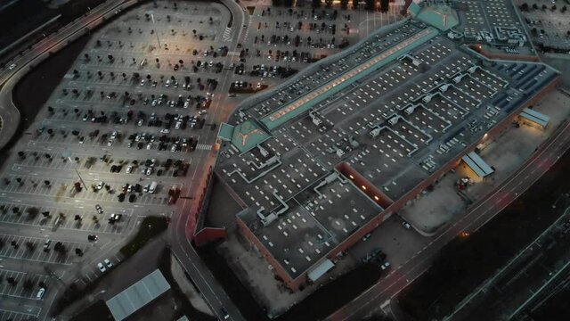 Spectacular aerial view with a mall and parking in the evening.