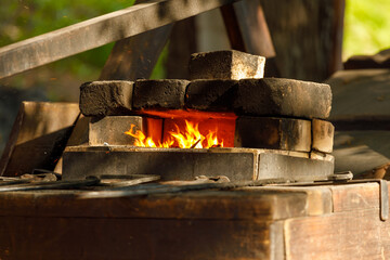 a burning forge made of bricks in nature