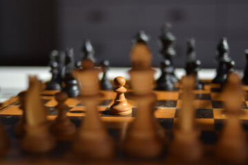 Closeup of a chess set with pawn in spotlight