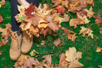 Woman holding a bouquet with maple leaves in her hands Autumn concept.
