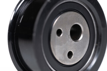 New timing belt tensioner roller close-up macro shot on gray background