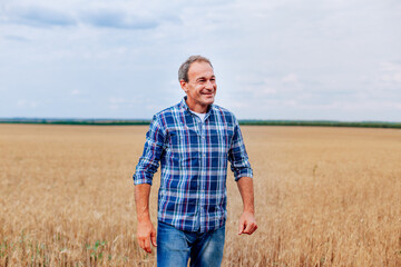 Old man smiling in wheat field farmer