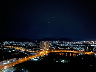 Panoramic wide scene in dark night with the colourful light of downtown