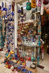 Bodrum, Turkey - August, 2020: Atmospheric local souvenir markets. Turkish Grand Bazaar. Hand-made souvenirs at street market. Souvenirs: wind music, dream catcher, evil eye keychain, beads, bracelets