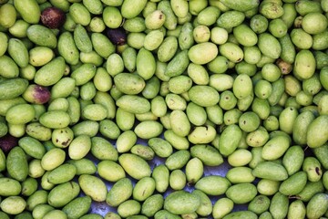 Stall with green olives at street market in Athens, Greece.