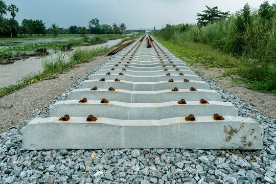 images of concrete sleepers for Railway rails on construction site Double track train. ,steel reinforced concrete. logistic and transportation concept