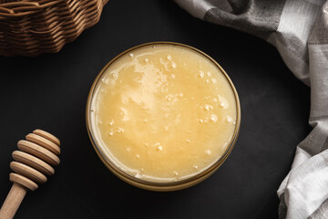 Thick light cream honey with a glass bowl top view
