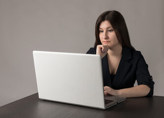 Young woman in blue with laptop.