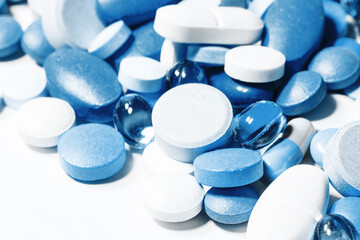 Blue tablets isolated on white. Medicine healthcare background. Drugs dose in group. Painkiller...
