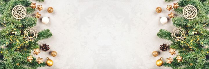 Christmas background of fir tree branches and decorations. The concept of the winter holidays. Flat lay, top view, copy space.