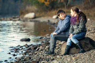 Couple of teenagers a date near the river. Nord of Russia.