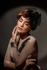 Obraz premium portrait of beautiful brunette woman posing in elegant hat