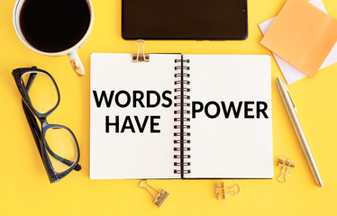 Words have power - text on notepad on yellow desk