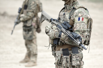 Soldiers with assault rifle and flag of France on military uniform. Collage.