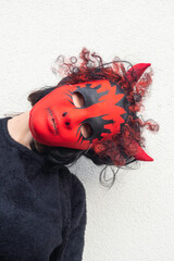 women with red devil mask, wear red horns