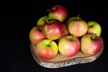 Fresh harvest of red apples on a black background, farm organic fruits
