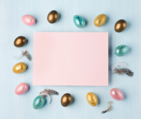 Naklejka na ściany i meble Easter greeting card with colorful easter eggs on blue background. Top view, flat lay with space for your text.