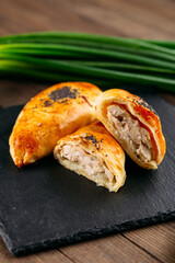 Cut oriental baked pie with chicken meat samsa