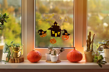 Happy halloween! The window of a house decorated for the holiday. Halloween decorations on window:...